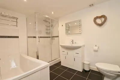 a bathroom with a sink toilet and a shower at Otters Holt in St Merryn