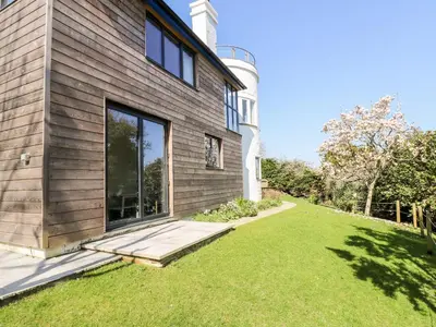 a house with a lawn in front of it at Dovefields in Helston