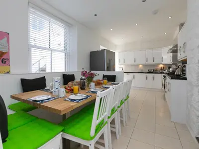 a kitchen and dining room with a wooden table and chairs at 6 Albany Terrace in St Ives