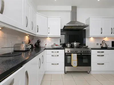 a kitchen with white cabinets and a stove top oven at 6 Albany Terrace in St Ives
