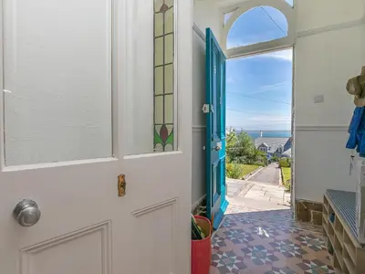 a door to a room with a view of the ocean at 6 Albany Terrace in St Ives