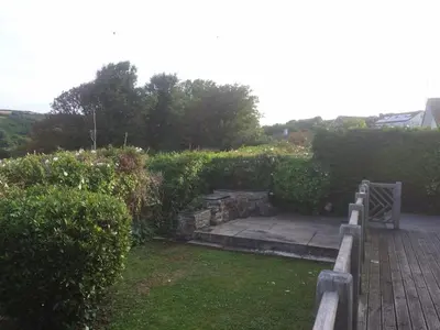 a garden with a wooden walkway and some bushes at Top Deck - Ancient Fishing Village - Near to the Beach! in Gorran Haven