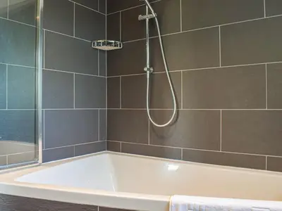 a bath tub in a bathroom with a shower at Top Deck - Ancient Fishing Village - Near to the Beach! in Gorran Haven