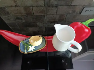 a white coffee cup and a chili on a table at Sunny-side-up in St Austell