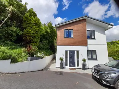 a house with a car parked in front of it at Sunny-side-up in St Austell