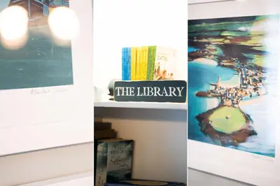 three pictures of the library and a shelf with books at Picture House in St Ives