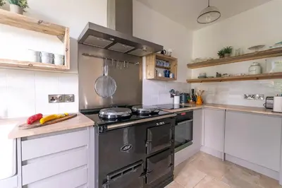 a kitchen with a stove and a counter top at Primrose Cottage in St Ives