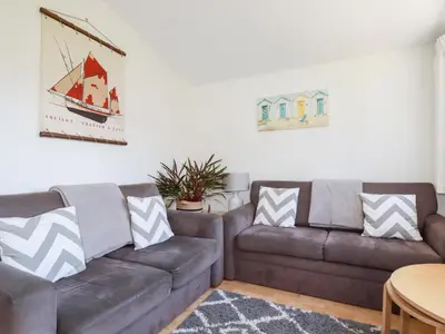 a living room with a couch and a table at 224 Atlantic Bays in Padstow