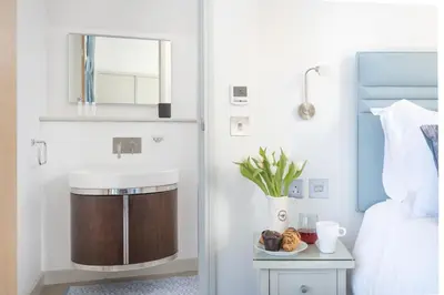 a bathroom with a sink and a bowl of food on a table at Harbour Master's House in Portreath