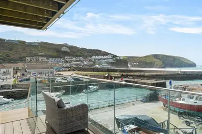 a balcony with a view of a marina at Harbour Master's House in Portreath