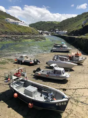 a group of boats sitting on the beach at Polrunny Farm Blackberry Cottage - Cornwall bliss in sight of the sea in Boscastle