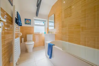 a bathroom with a tub and a toilet and a sink at Polrunny Farm Blackberry Cottage - Cornwall bliss in sight of the sea in Boscastle