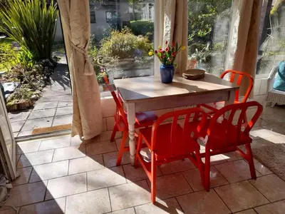 a red table and chairs on a patio at Blue Skies in St Ives