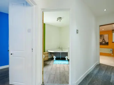 a bathroom with a bath tub in a room at By The Beach in Torpoint