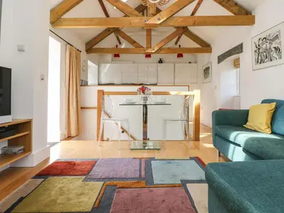 a living room with a table and a couch at Little Chygowlin in Truro