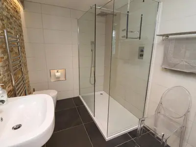 a bathroom with a shower and a sink and a toilet at Little Chygowlin in Truro