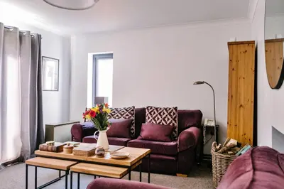 a living room with a couch and a table at Finest Retreats - Charnwood in Lewannick