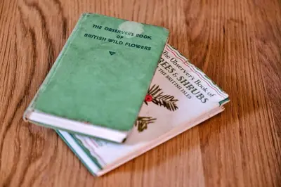 two books stacked on top of each other on a table at Finest Retreats - Charnwood in Lewannick