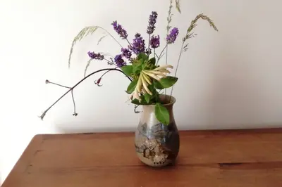 a vase with purple flowers in it sitting on a table at Farm accommodation - The Lizard Peninsula, Cornwall in Helston