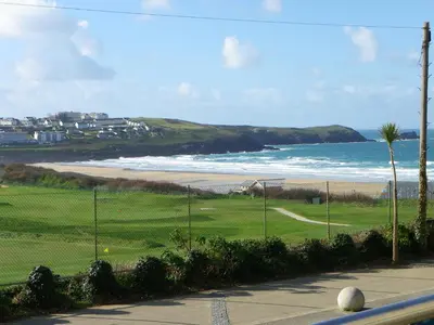 a view of a golf course and the ocean at Ollies 4 Cribbar in Newquay