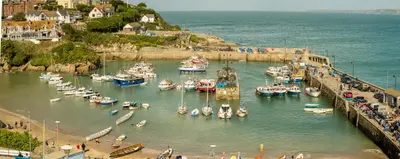 a group of boats are docked in a harbor at Ollies 4 Cribbar in Newquay