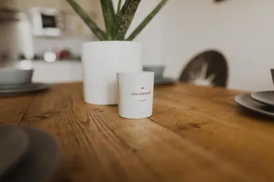 a white cup sitting on a wooden table at Ocean 1- Sea View apartment, Fistral Beach Newquay in Newquay