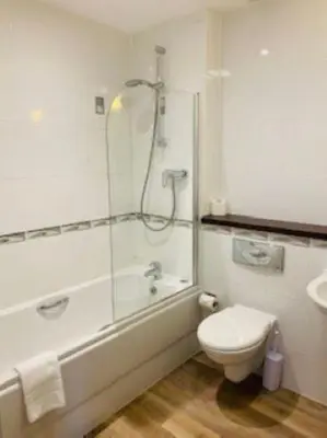 a bathroom with a shower and a toilet and a sink at Ocean 1- Sea View apartment, Fistral Beach Newquay in Newquay