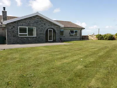 a house with a large lawn in front of it at Boscastle View in Boscastle