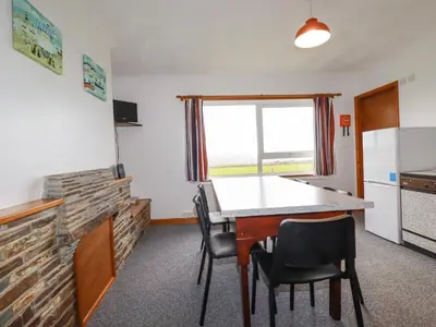 a kitchen with a table and chairs in a room at Boscastle View in Boscastle