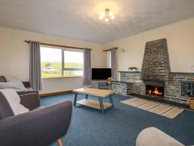 a living room with a couch and a fireplace at Boscastle View in Boscastle