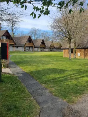 a house with a green yard with a red telephone box at Blissful Escape Hengar Manor in Bodmin