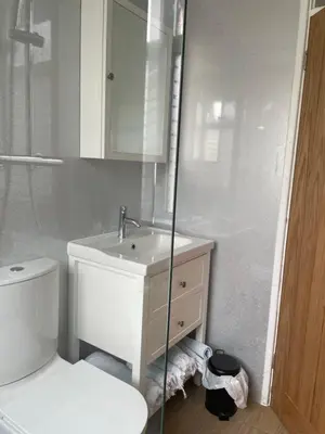a bathroom with a toilet and a sink and a shower at SunnyVale Valley View Cottage in Gorran Haven