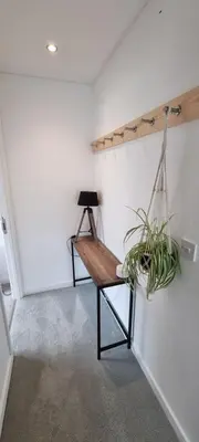 a room with a wooden bench and a plant at Hidden Gem near the beach with pool table in Newquay