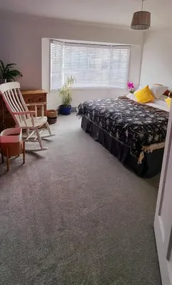 a bedroom with a bed and a chair and a window at Hidden Gem near the beach with pool table in Newquay