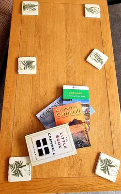 a wooden table with books and cards on it at Hidden Gem near the beach with pool table in Newquay