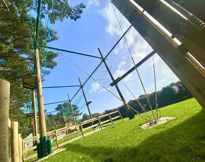 a swing in a grassy field next to a fence at Dog Friendly 8 Berth Static Caravan Newquay in Newquay