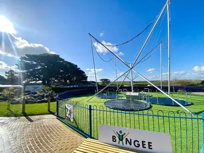 a fence with a playground in a park at Dog Friendly 8 Berth Static Caravan Newquay in Newquay