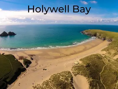 a view of a beach with the words holywell bay at Dog Friendly 8 Berth Static Caravan Newquay in Newquay