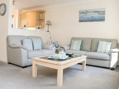 a living room with two couches and a coffee table at Owls Roost in Falmouth