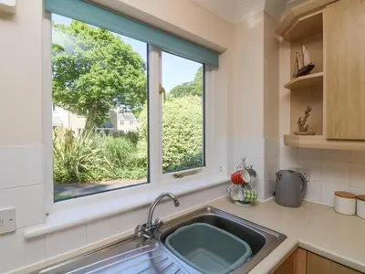 a kitchen with a sink and a window at Owls Roost in Falmouth