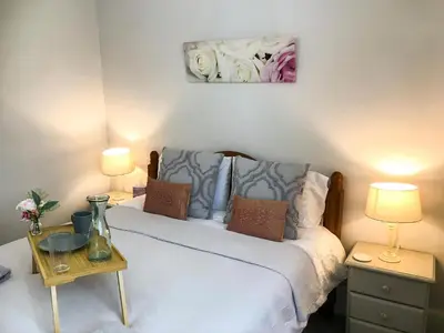 a bedroom with a white bed with two lamps at The Cornish Peak Beautiful Apartment In Grade 2 Listed Building In Cornwall By STAE-Homes in Camelford
