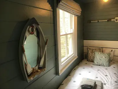 a bedroom with a mirror and a bed in it at The Cornish Peak Beautiful Apartment In Grade 2 Listed Building In Cornwall By STAE-Homes in Camelford