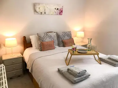 a bedroom with a bed with a table on it at The Cornish Peak Beautiful Apartment In Grade 2 Listed Building In Cornwall By STAE-Homes in Camelford