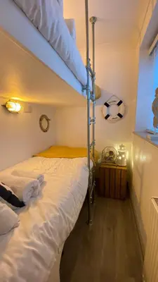 a bedroom with a bunk bed with a soccer ball at ABOVE PORTHMINSTER BEACH - 