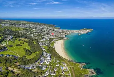 an aerial view of a beach and the ocean at ABOVE PORTHMINSTER BEACH - 