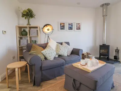a living room with a couch and a table at Badgers Way in Tintagel