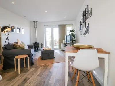 a living room with a couch and a table at Badgers Way in Tintagel