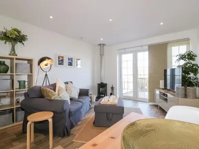 a living room with a couch and a table at Badgers Way in Tintagel