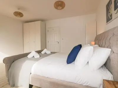 a bedroom with a large white bed with pillows at Crabs and Lobsters in Newquay