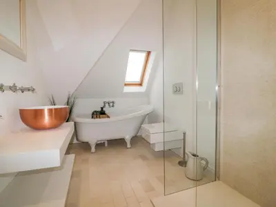 a bathroom with a tub and a toilet and a sink at Crabs and Lobsters in Newquay